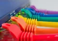 Close-up macro photograph of colorful Ethernet cable wires arranged against a white background.