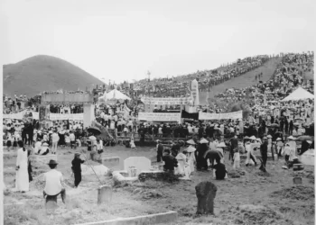City officials in Hue, Vietnam, arrange coffins before funeral services for victims of the 1968 Tet Offensive, in a U.S. military archival photograph.