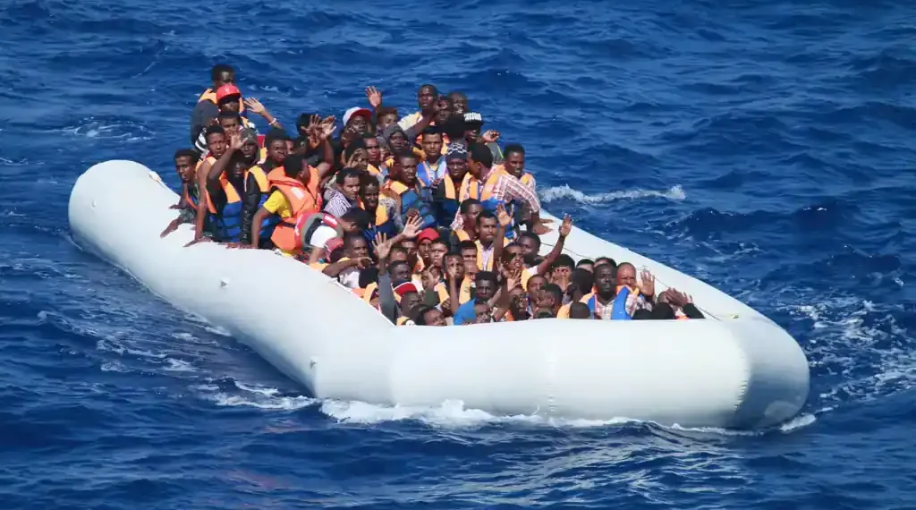 Migrants aboard an inflatable vessel approach USS Carney in the Mediterranean Sea on July 29, 2016, during a U.S. Navy rescue operation.