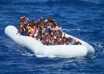 Migrants aboard an inflatable vessel approach USS Carney in the Mediterranean Sea on July 29, 2016, during a U.S. Navy rescue operation.