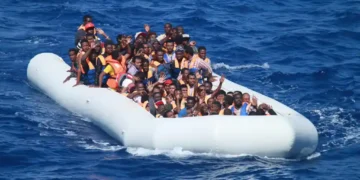 Migrants aboard an inflatable vessel approach USS Carney in the Mediterranean Sea on July 29, 2016, during a U.S. Navy rescue operation.