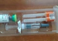 Priorix measles, mumps and rubella vaccine vial with a pre-filled solvent syringe and two protected hypodermic needles.