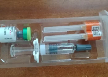 Priorix measles, mumps and rubella vaccine vial with a pre-filled solvent syringe and two protected hypodermic needles.