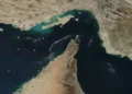 Satellite image of the Strait of Hormuz and Musandam Peninsula, showing rugged coastal mountains between Iran, Oman, and the United Arab Emirates.