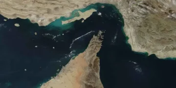 Satellite image of the Strait of Hormuz and Musandam Peninsula, showing rugged coastal mountains between Iran, Oman, and the United Arab Emirates.