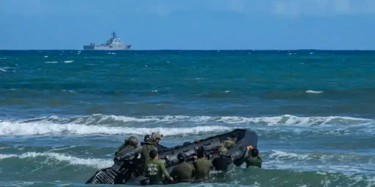 U.S. Naval Special Warfare operators and Japanese Self-Defense Force soldiers navigate a combat rubber raiding craft through surf during Keen Sword 25 near Tokunoshima, Japan, on October 26, 2024.